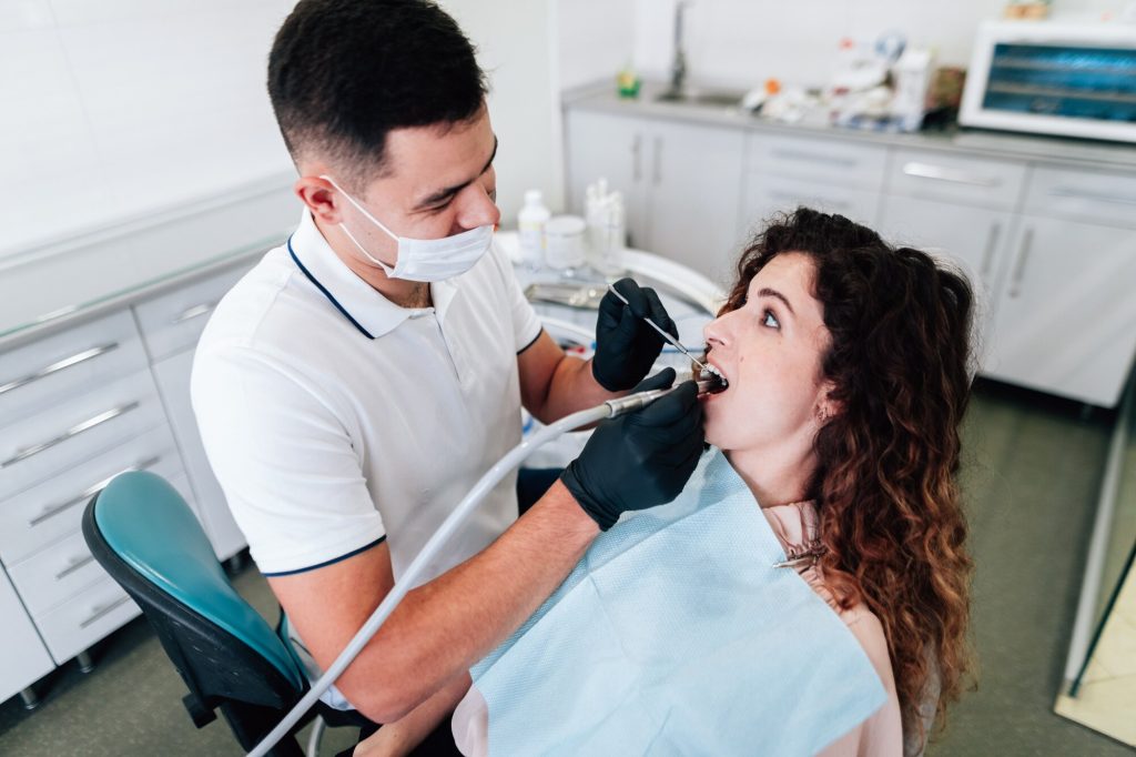 dentist performing routine oral exam Windsor